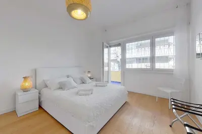 a bedroom with a white bed with two towels on it at Hyaline Gregorio VII in Rome