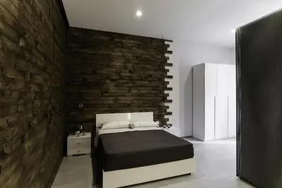 a bedroom with a bed and a brick wall at B&B Girovagando in Rome