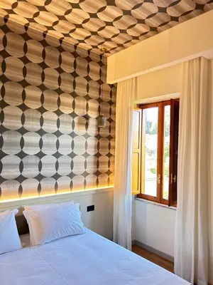a bedroom with a bed and a wall with a window at Residenza Leone XIII in Rome