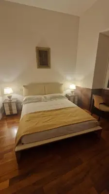 a large bed in a room with two lamps at Luxury Apartment delle Fratte in Rome