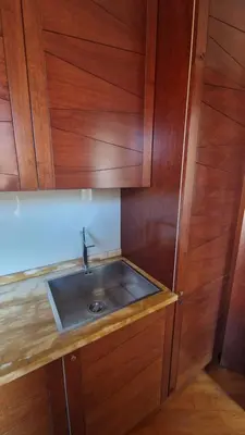 a kitchen with a sink and wooden cabinets at Luxury Apartment delle Fratte in Rome