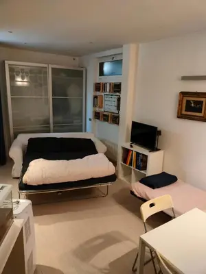 a bedroom with a bed and a tv in it at Euclide apartment in Rome