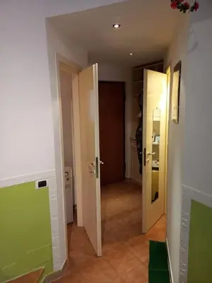 an empty room with a hallway with two open doors at Green House Roma in Rome