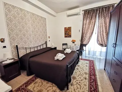 a bedroom with a bed in a room at B&B Divina Roma in Rome