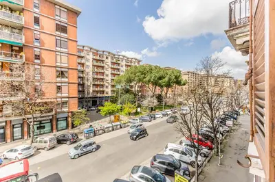a city street with cars parked in a parking lot at La Casetta Trastevere in Rome