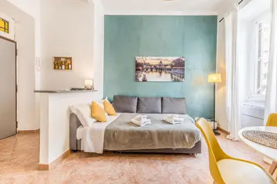 a bedroom with a bed and a table and chairs at La Casetta Trastevere in Rome