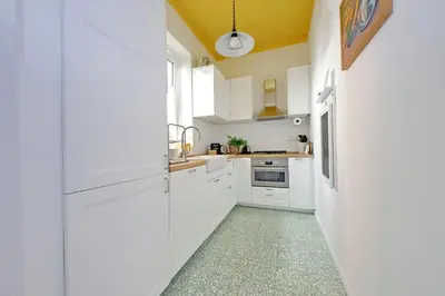 a kitchen with white cabinets and a sink at Casa Giubbonari con terrazzo in Rome