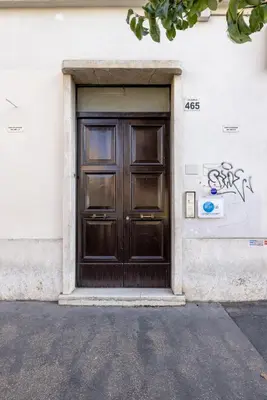 a wooden door on a building with graffiti on it at Casa EMMA, casa vacanze Aurelio in Rome