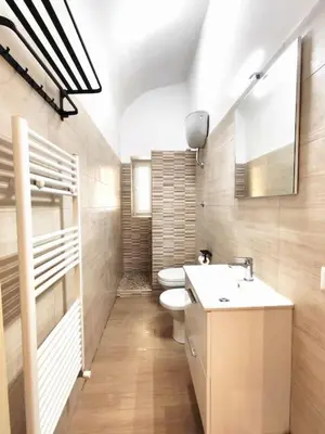 a bathroom with a toilet and a sink at The Gold Apartment in Rome