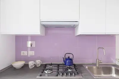 a kitchen with a stove with a blue tea kettle on it at HospitalityRome Sunny San Lorenzo in Rome