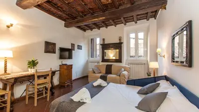 a bedroom with a bed and a living room with a table at Scala Studio by Rental in Rome in Rome