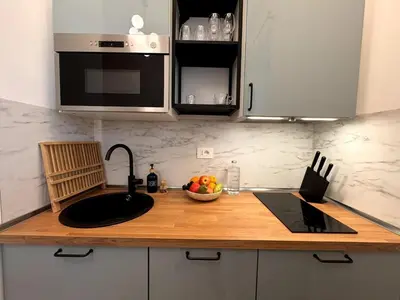 a kitchen counter with a sink and a bowl of fruit at Kaizen The Barista 3BR Apartment With Coffee Station in Rome