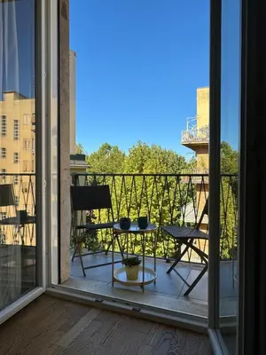 a balcony with a table and chairs on a balcony at The 7th Apartment in Rome