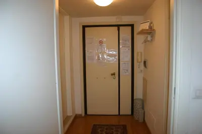 a hallway with a door with a sign on it at La CASA di EMY in Rome