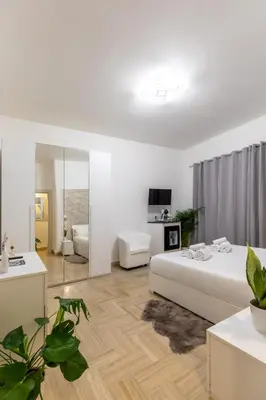 a kitchen and dining room with wooden cabinets and a table at Gregorio VII Luxury Home Apartment in Rome