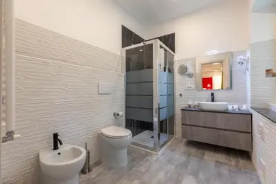 a bathroom with a sink and a mirror at Gregorio VII Luxury Home Apartment in Rome