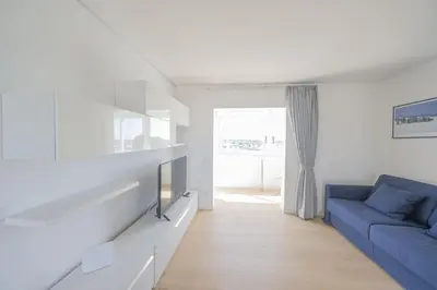 a living room with a blue couch and a tv at Caffarella Park Terraced 2BR Apartment in Rome