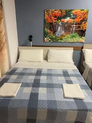 a bed in a room with a painting on the wall at Parenti B&B in Rome