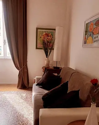 a living room with a couch and a table with flowers at Rome Appartment in Rome