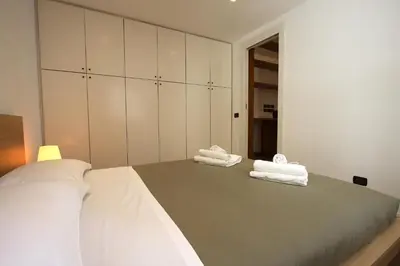 a bedroom with white towels on a bed at Ponte Milvio Lovely Garden in Rome