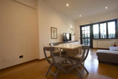 a living room with a table and a couch at Ponte Milvio Lovely Garden in Rome