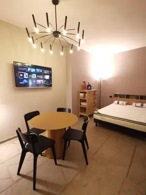a room with a table and chairs and a bed at Auri Vatican apartment in Rome