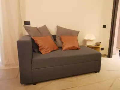 a couch with three pillows on it in a living room at Auri Vatican apartment in Rome