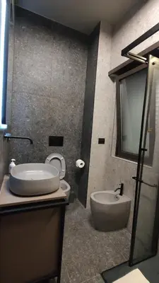 a bathroom with a sink and a tub and a toilet at Auri Vatican apartment in Rome
