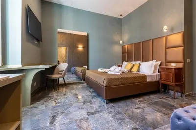 a hotel room with a bed and a desk at Piazza di Spagna 51 Luxury guest house in Rome