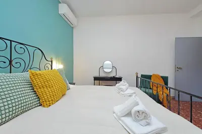 a bedroom with a white bed with towels on it at TM Apartment in Rome