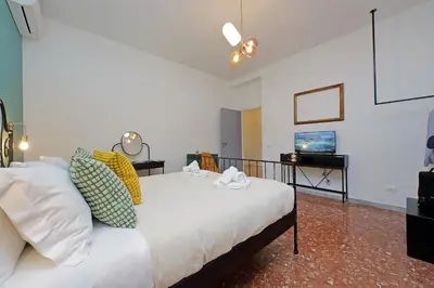 a bedroom with a bed and a television in it at TM Apartment in Rome