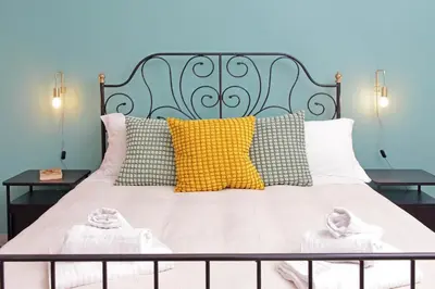 a bed with two baby slippers on top of it at TM Apartment in Rome