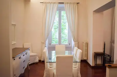 a living room with a glass table and a window at Casa Ale in Rome
