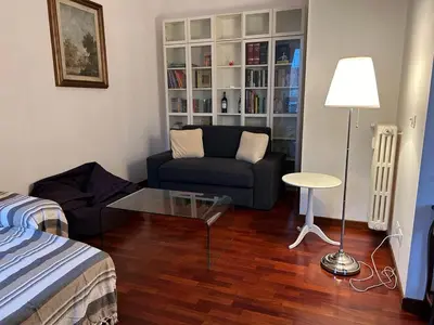 a living room with a couch and a glass table at Casa Ale in Rome