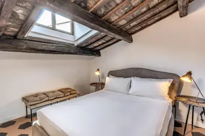 a bedroom with a white bed and a window at Cisterna 8 in Rome