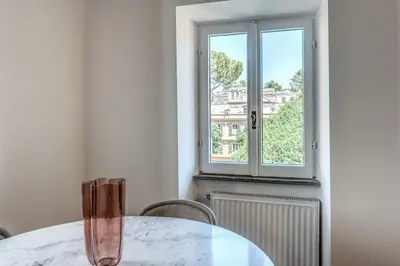 a dining room with a table and a window at Cisterna 9 in Rome