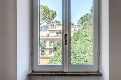 a window with a view of a building at Cisterna 9 in Rome
