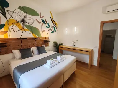 a bedroom with a large bed with towels on it at The Holy Apartments in Rome