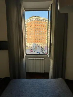 a bedroom window with a view of a building at A Colorful Spot for La Dolce Vita in Rome