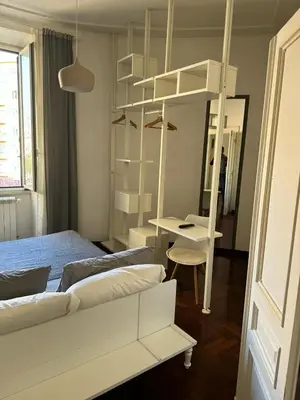 a bedroom with a white bunk bed and a desk at A Colorful Spot for La Dolce Vita in Rome
