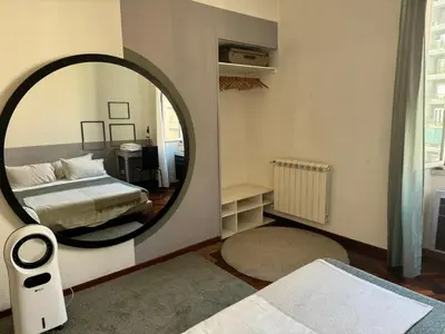 a bedroom with a bed and a large mirror at A Colorful Spot for La Dolce Vita in Rome