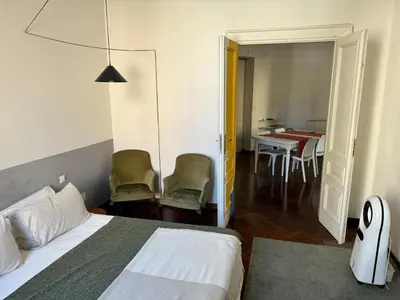 a bedroom with a bed and a table and chairs at A Colorful Spot for La Dolce Vita in Rome