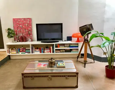 a living room with a tv and a coffee table at Stylish Duplex Apartment with Private Terrace in Rome