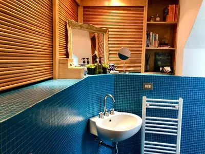 a bathroom with a sink and a mirror at Stylish Duplex Apartment with Private Terrace in Rome