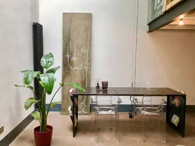 a dining room with a black table and chairs at Stylish Duplex Apartment with Private Terrace in Rome