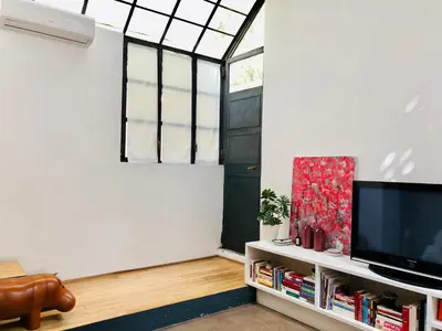 a living room with a tv and a window at Stylish Duplex Apartment with Private Terrace in Rome