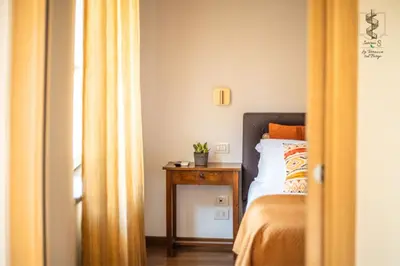 a bedroom with a bed and a side table at Interno Otto con Bellissima Terrazza e Gazebo in Rome