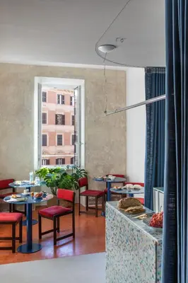 a restaurant with tables and chairs and a large window at Ehi Bnb in Rome