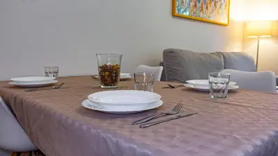 a table with plates and utensils on top of it at Re di Roma Metro Hub - Rome Collection in Rome