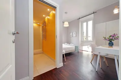 a room with a bedroom and a table and a bed at 4BNB - Armot House Vatican Apartment in Rome